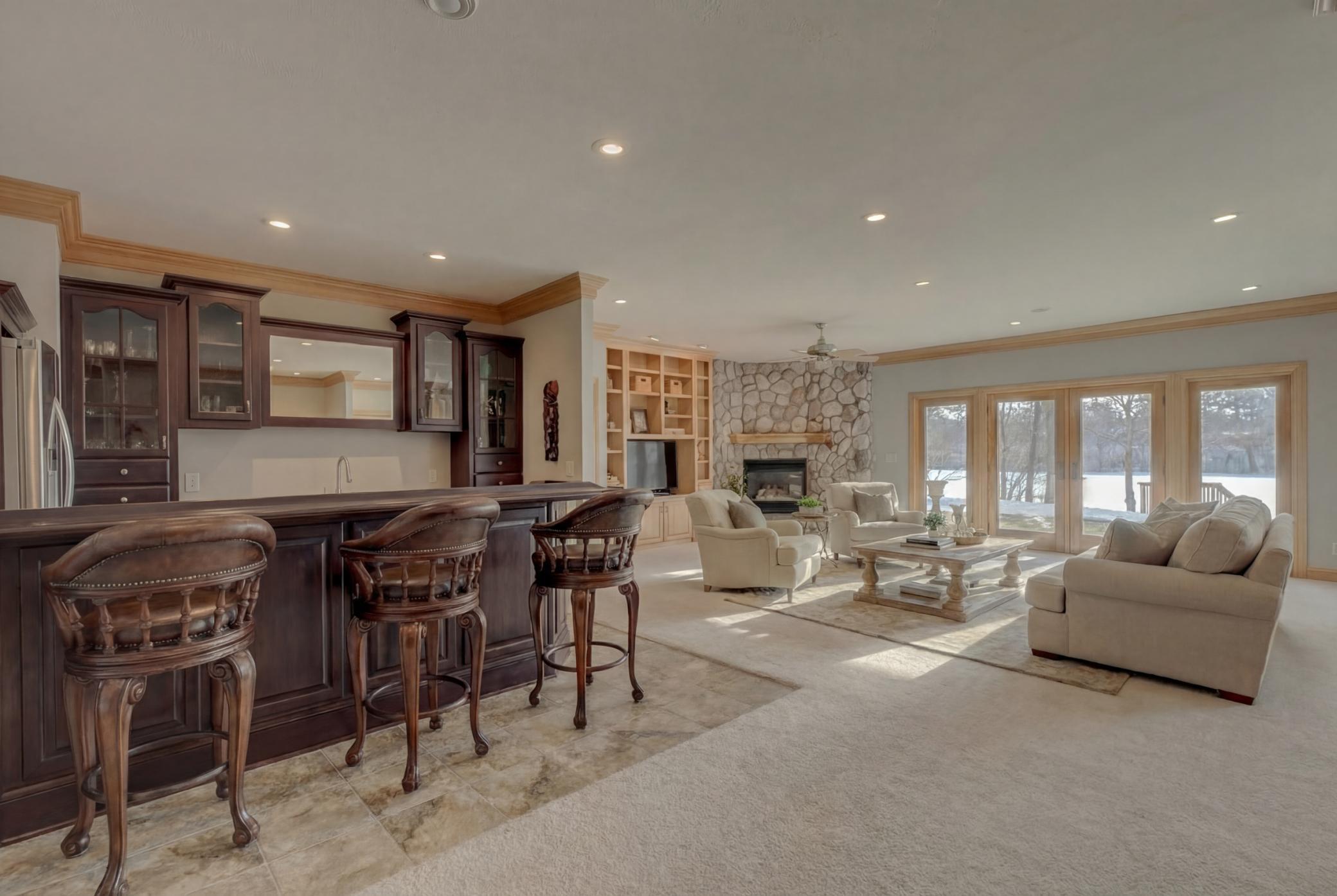 The walkout lower-level features three additional bedrooms, each with large walk-in closets, offering plenty of space for guests. (virtually staged)