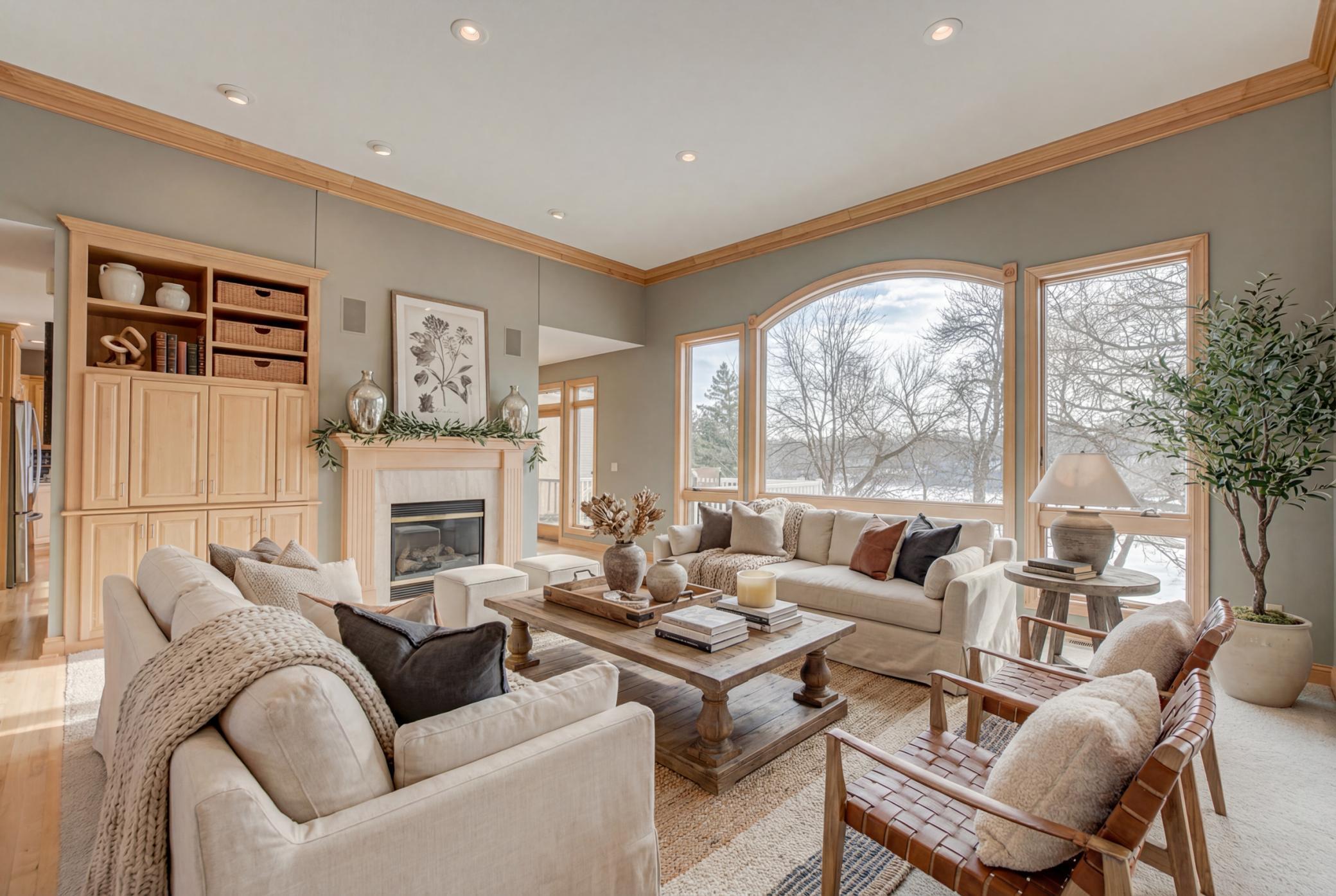 The home features expansive windows that flood the living spaces with natural light and showcase breathtaking lake views. (virtually staged)