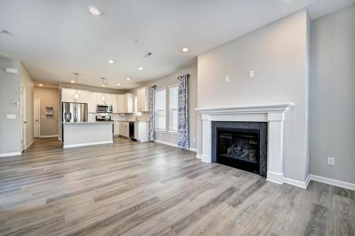 View of Kitchen and Fireplace from Living Room. Front Door is to the Left..jpg