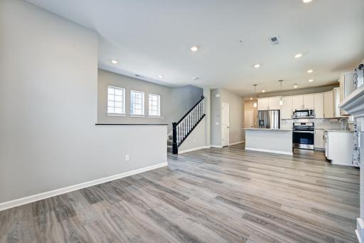 View of Kitchen and Stairs from Living Room. Fireplace is to the Right.jpg
