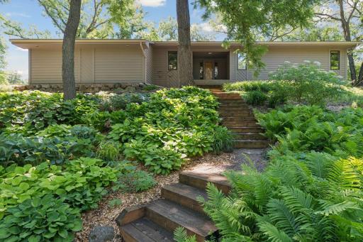 Photo for 4309 Tonkawood Road, Minnetonka, MN 55345 - listing #7029883 Lush landscaping and mature trees create a private, welcoming approach to the home