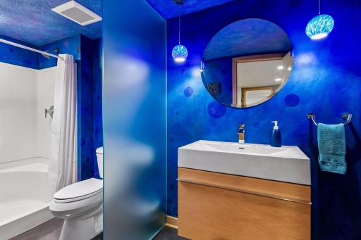 A stylish lower-level bathroom adds convenience to the home’s versatile living spaces.