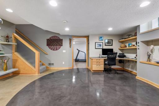 Polished concrete floors continue into a flexible workspace with convenient built-in storage.
