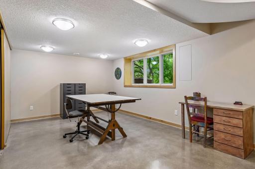 Large windows bring natural light into this flexible lower-level recreation space.