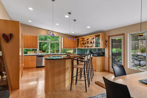 Gourmet kitchen features quarter-sawn maple cabinetry and Norway Emerald Pearl granite.