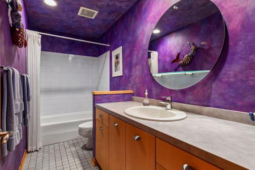 A full bathroom features generous vanity space and a tub-shower combination.
