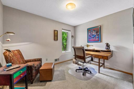 The third main-level bedroom offers flexibility for guests, work, or hobbies