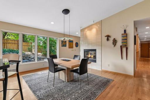 The dining room features hardwood floors and a warm two-sided fireplace.
