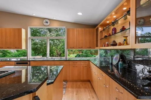 Abundant cabinetry and pull-out storage maximize functionality throughout the gourmet kitchen.
