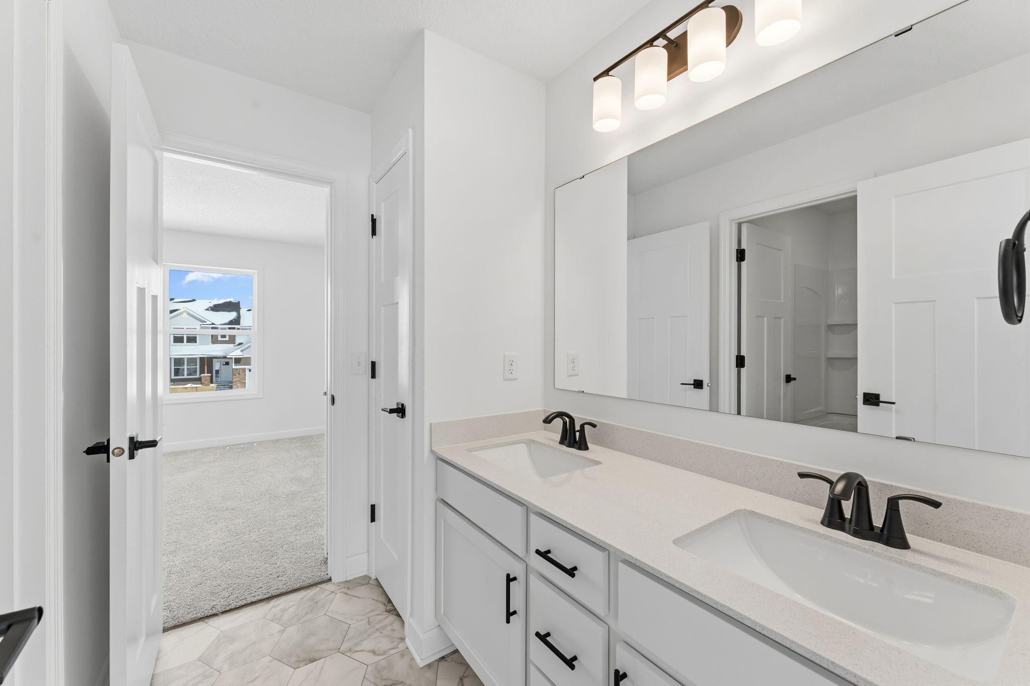 This Jack-and-Jill bathroom connects two of the secondary bedrooms.