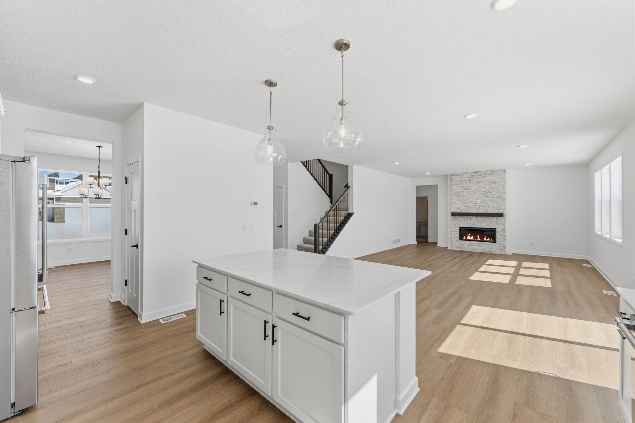 The center island extends out to a breakfast bar for casual meals