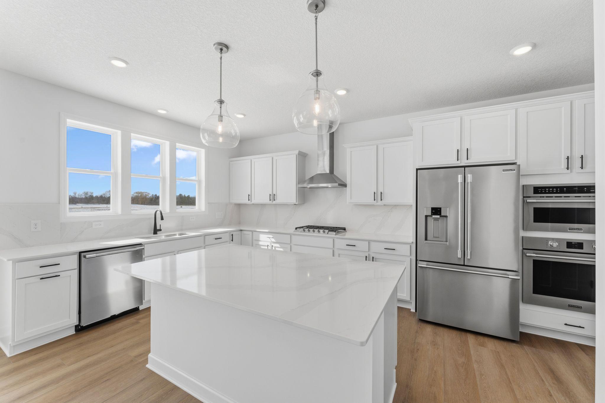The spacious kitchen naturally serves as the heart of this home, complete with a generous center island, brand-new appliances and a walk-in pantry.