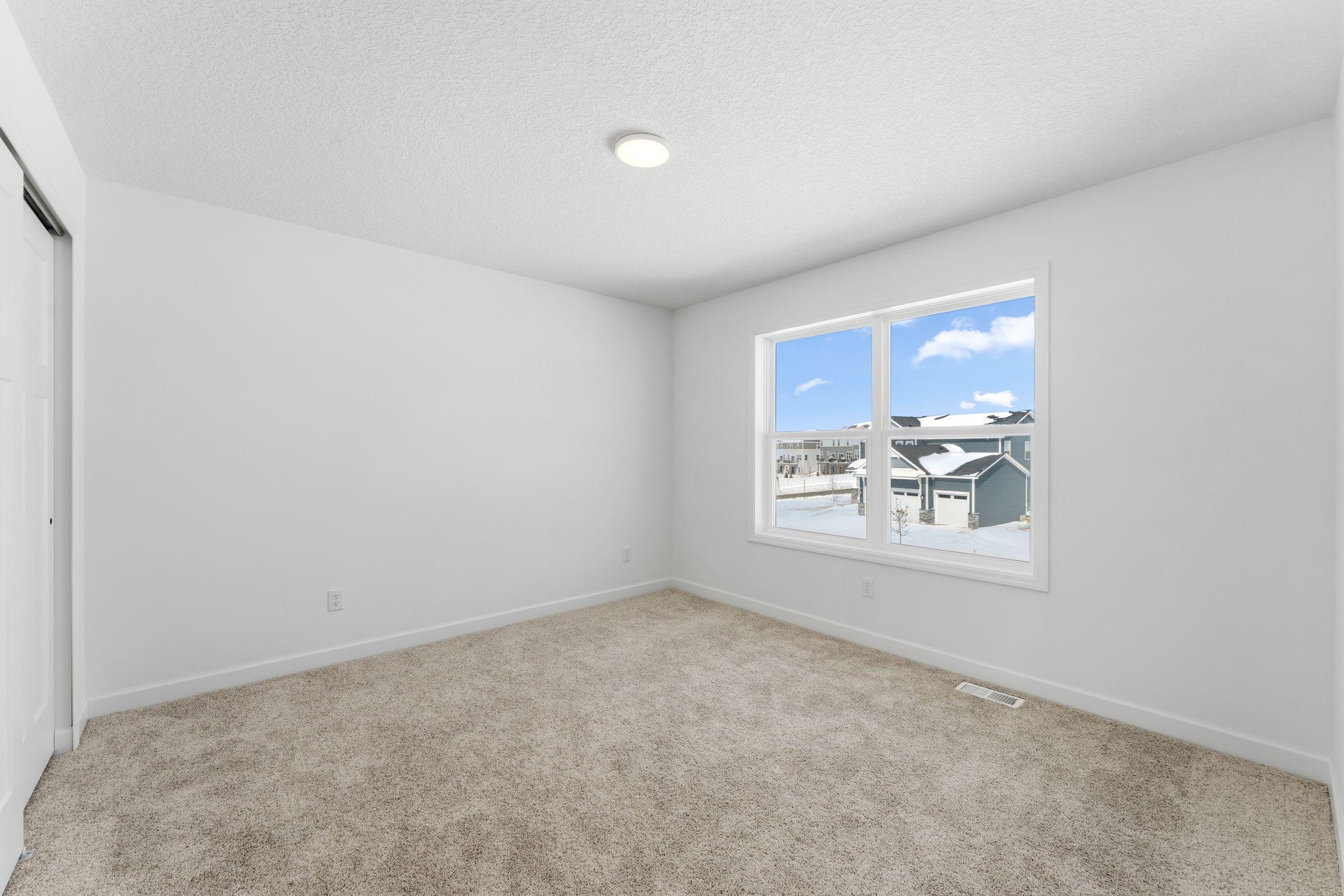 Three secondary bedrooms are located on the second floor.