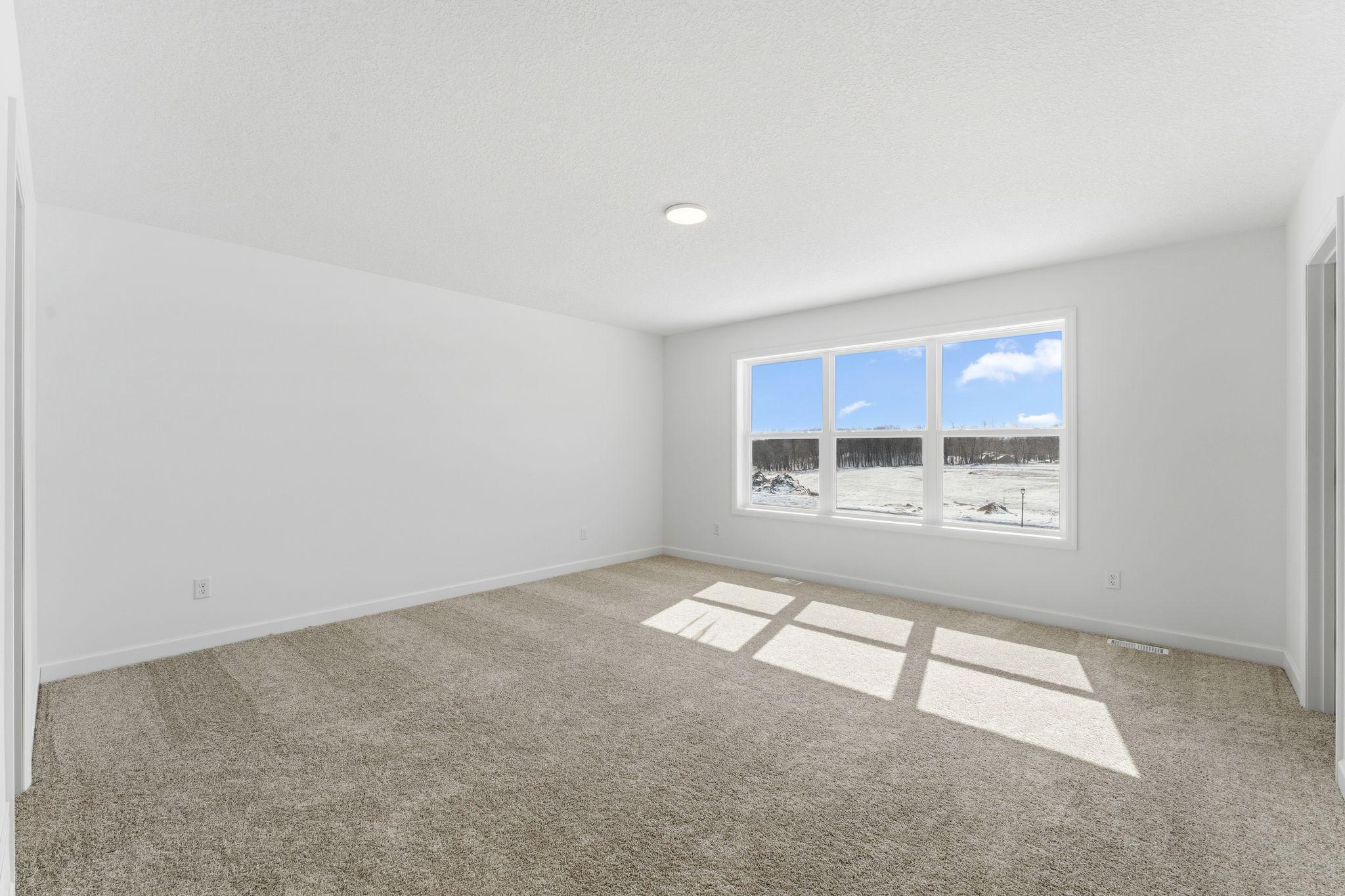 The expansive owner’s suite is located on the second level, complete with a restful bedroom, an en-suite bathroom and two walk-in closets.