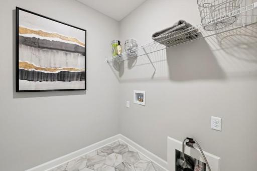 (Photo of a decorated model, actual features will vary) Centrally located on the upper level, along with the three bedrooms, this laundry room provides the ultimate convenience.