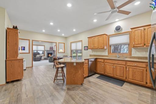 Kitchen boasts natural stone countertops and a peninsula island.