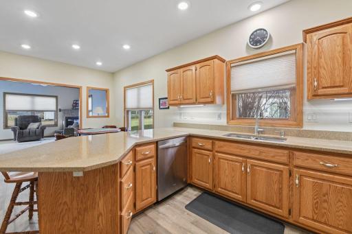 Then the lovely kitchen featuring a gourmet style, stone tops, peninsula island and modern backsplash will surely impress.