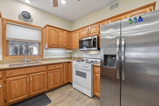 Modern, open kitchen with oak cabinets.