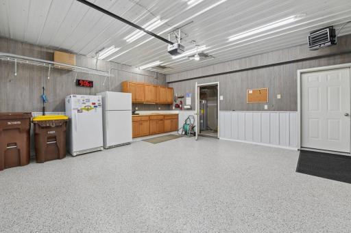 Breathtaking and tastefully remodeled! Epoxy floor, wall and ceiling paneling and upper and lower cabinets. Then notice the new garage door and opener, refrigerator and freezer and water spigot. Amazingly clean!