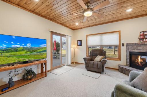 Sunroom with sliding glass door to patio and gardens.