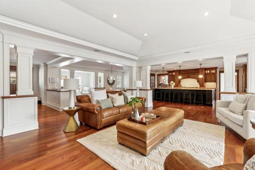 Soaring tray-vaulted ceilings, rich hardwood floors, and stately pilasters frame the grand living room of this open-concept, one-level Edina gem at 6601 Dovre Drive.
