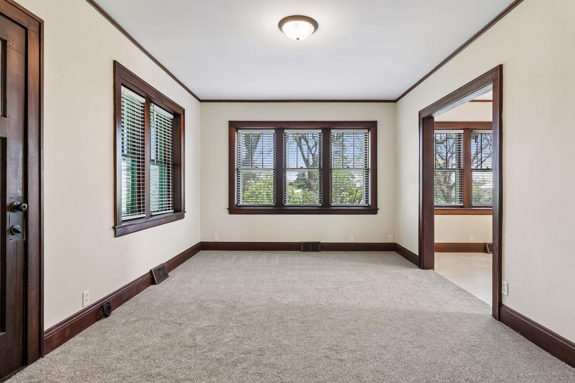 Bright and airy living room with beautiful windows - crystal clean and move-in ready. Ceiling was also painted.