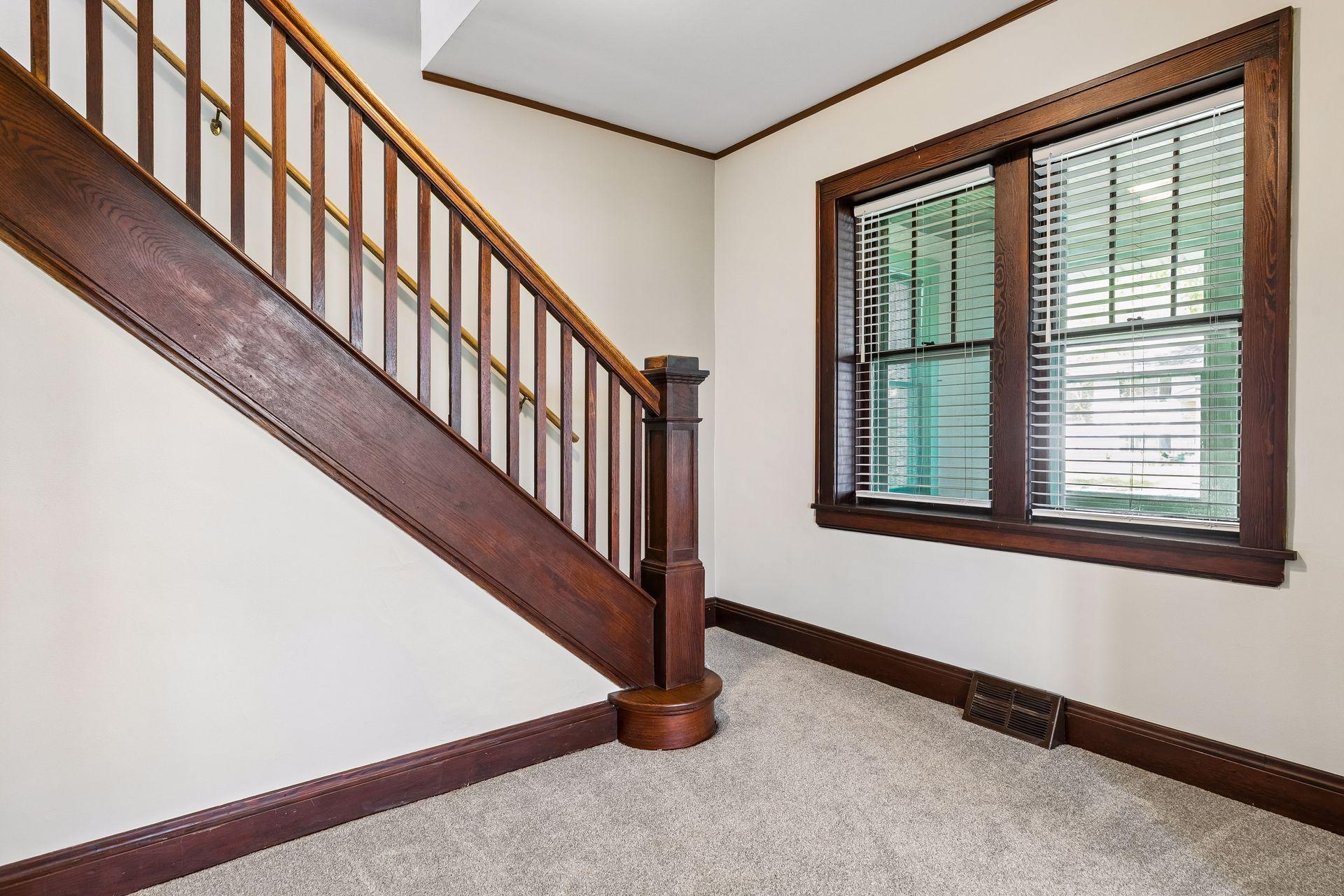 Original natural woodwork throughout the home including baseboards, trim, banister, and doors.