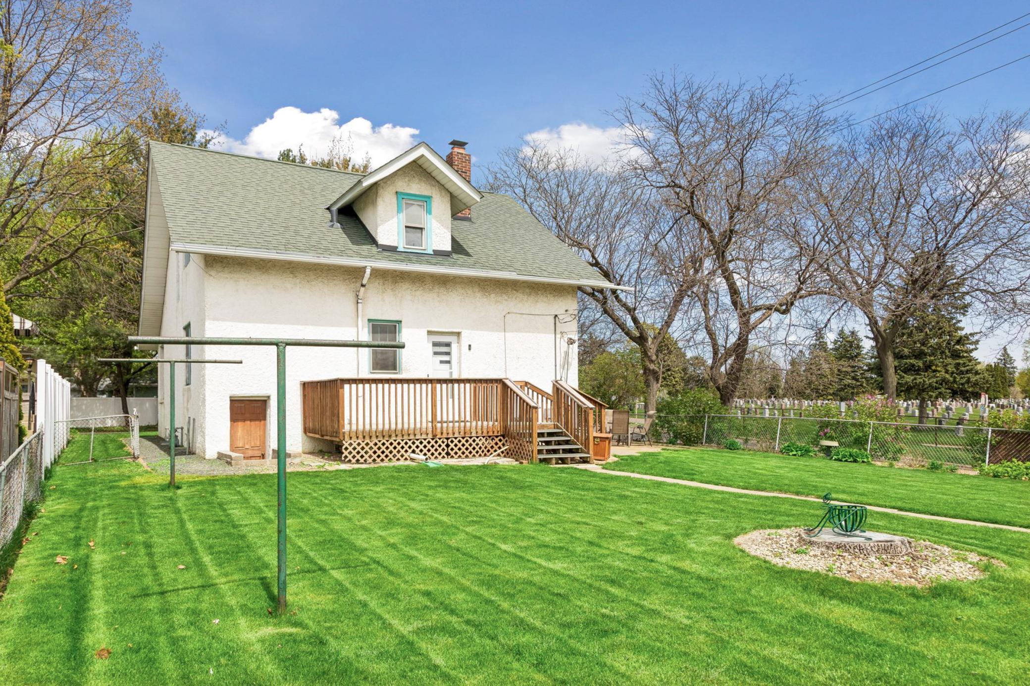 Manicured lush lawn and gardens.