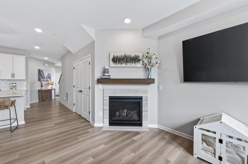 Fireplace w/ quartz surround and driftwood mantle.