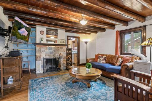 Living room with wood burning fireplace and updated surround.