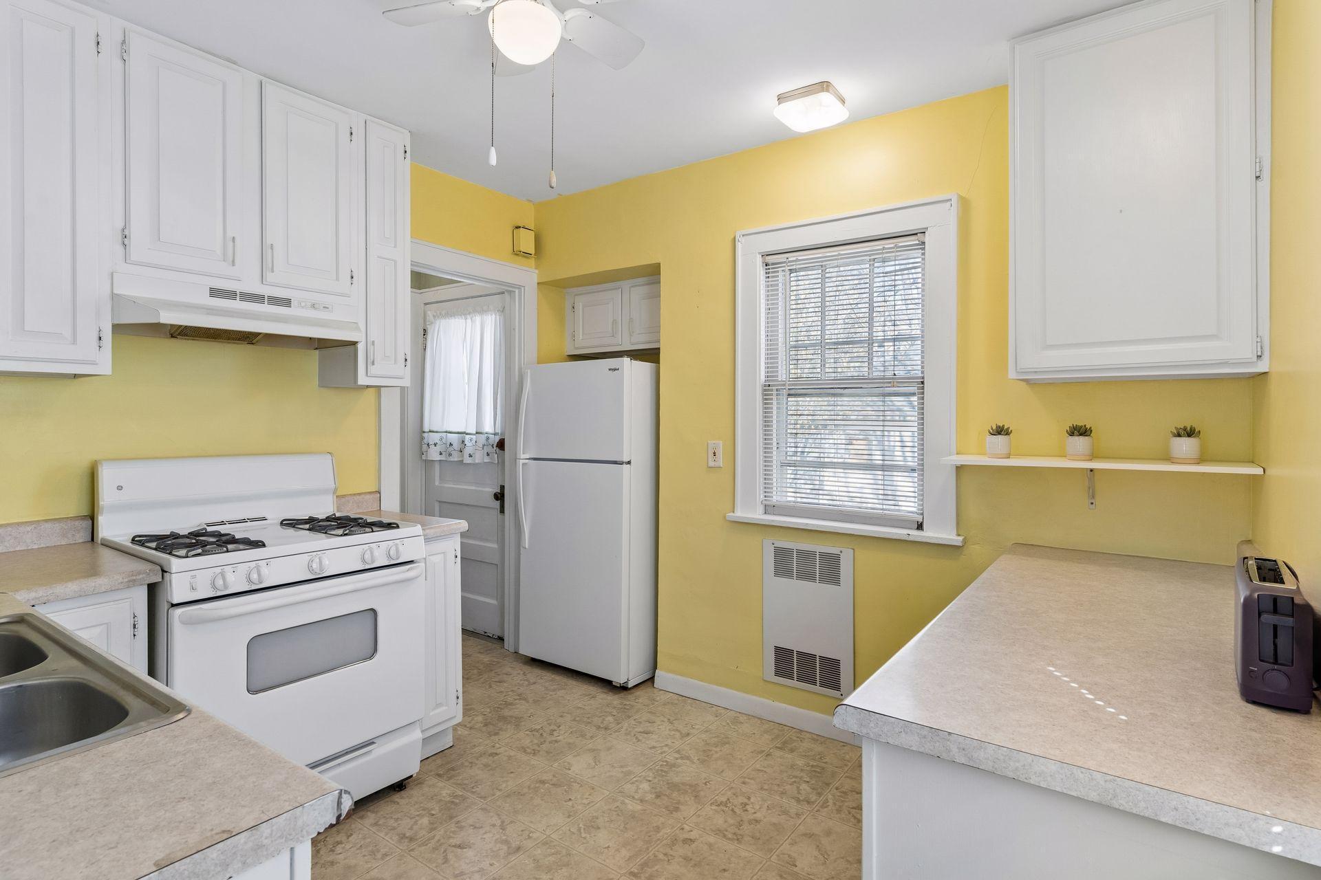 Bright kitchen with window overlooking back yard.