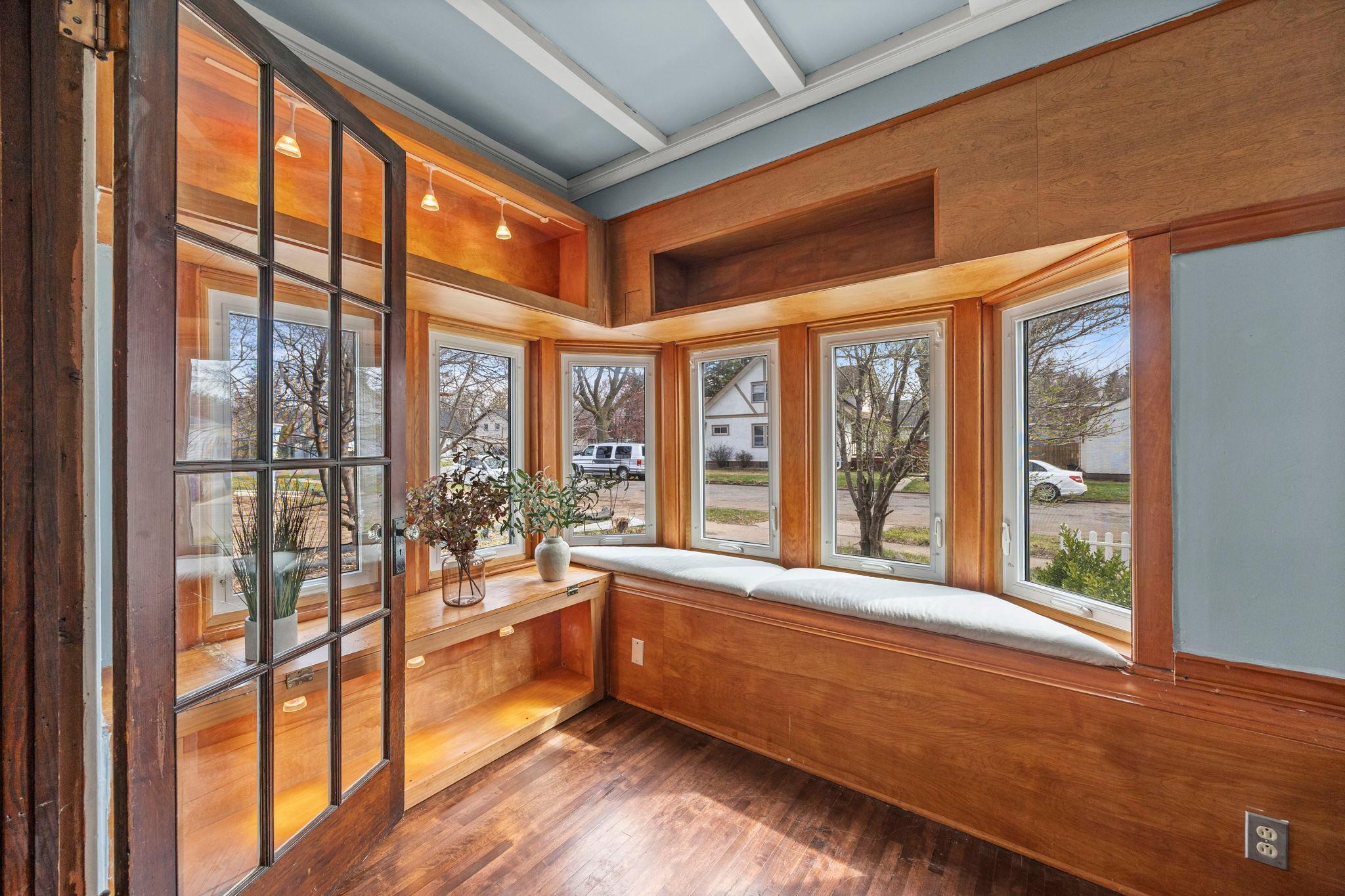 The sunroom has lots of built-ins and beautiful, updated windows.