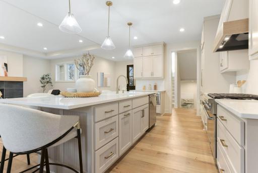A quartz island countertop is the kitchenâs centerpiece, offering durability, sophistication, ample workspace, storage, and casual dining.