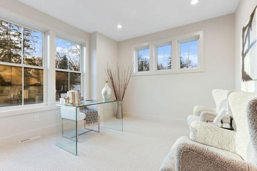 A main-level bedroom offers ideal flexibility for guests, a private office, or multigenerational living.
