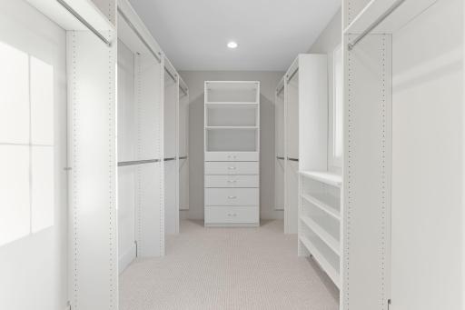 The primary bedroom also has a generously sized walk-in closet with custom built-ins, ensuring ample storage and organization.