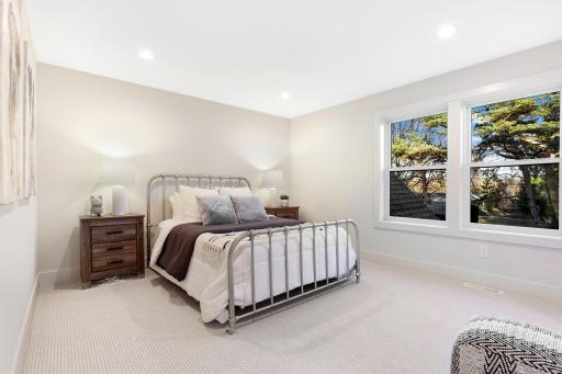 Offering extra privacy, this bedroom includes its own Â¾ bathroom with contemporary fixtures and a walk-in closet, making it perfect for guests.