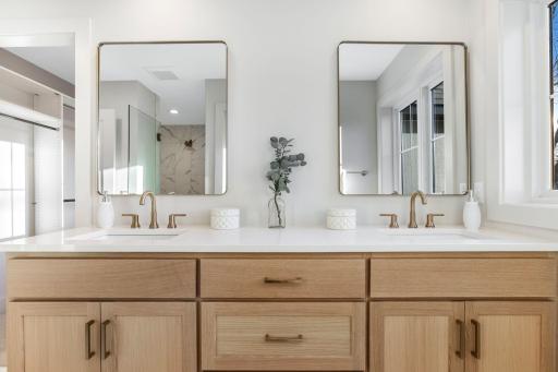 The en-suite bathroom is a true highlight, featuring a dual sink vanity and a private commode for added privacy.