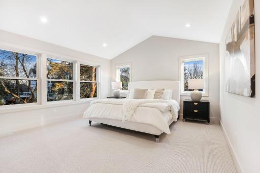 The primary bedroom is a serene retreat with an impressive vaulted ceiling that enhance the sense of space.