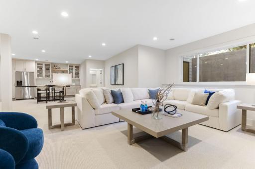 The lower level of this home is a well-appointed space designed for entertaining with nine foot ceilings, featuring high-end finishes and thoughtful details.