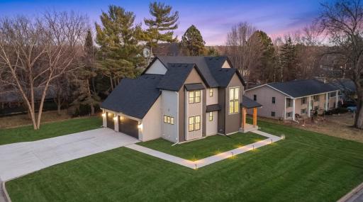 The insulated three car garage is designed for Minnesota living, featuring a floor drain and a gas line rough-in for a future heater. ***Landscaping shown is for illustrative purposes only