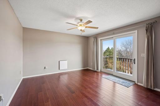Upper level primary bedroom with sliding door to balcony.