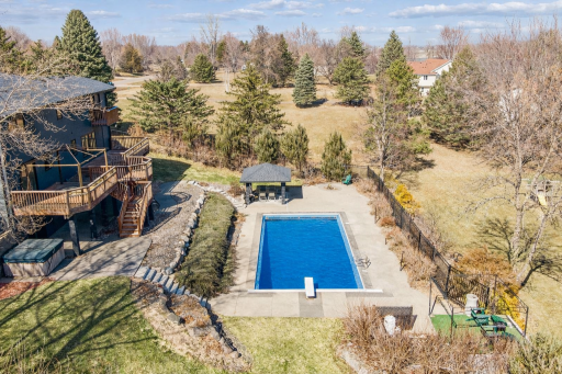 Huge patio under the deck complete with hot tub, kennel off the garage, majestic boulder retaining walls with Chilton stone stairways down to the oversized pool deck level complete with a Cabana for a shade break.