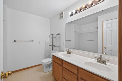 Bright and roomy full bath featuring dual sinks and plenty of storage to keep mornings moving smoothly.