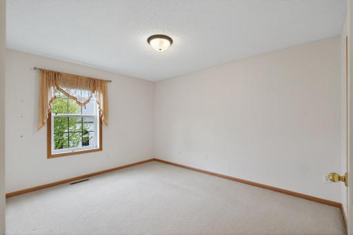 Versatile upper-level bedroom perfect for guests, kids, or a tucked-away home office.