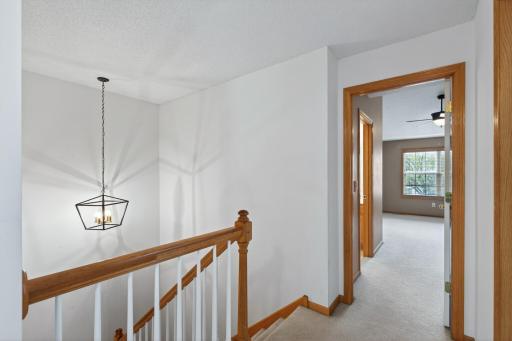 Open upper-level hallway overlooking the dramatic two-story living area below.
