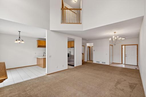 The open-concept layout creates an easy flow between the living, dining, and kitchen spaces while the upper-level overlook adds architectural character.
