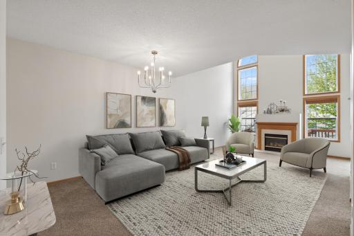 A warm and welcoming gathering space with vaulted ceilings, abundant natural light, and room to comfortably entertain or unwind. Virtually Staged