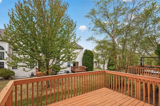 Spacious deck overlooking mature trees and open green space creates the perfect outdoor escape.