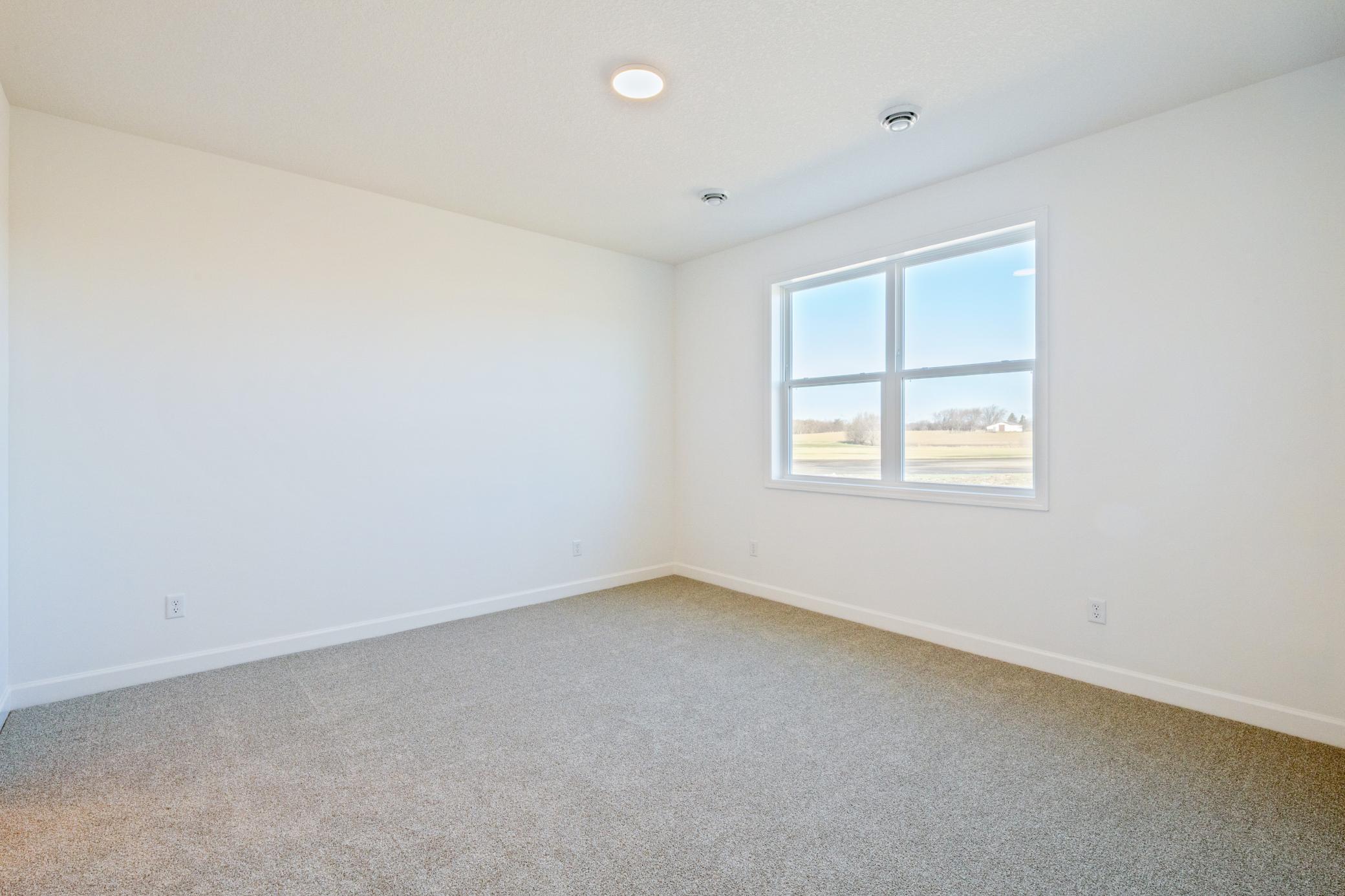 (Photo of a similar home, actual finishes may vary) Made for rest and relaxation, the owner’s suite features a luxe bathroom and a walk-in closet.