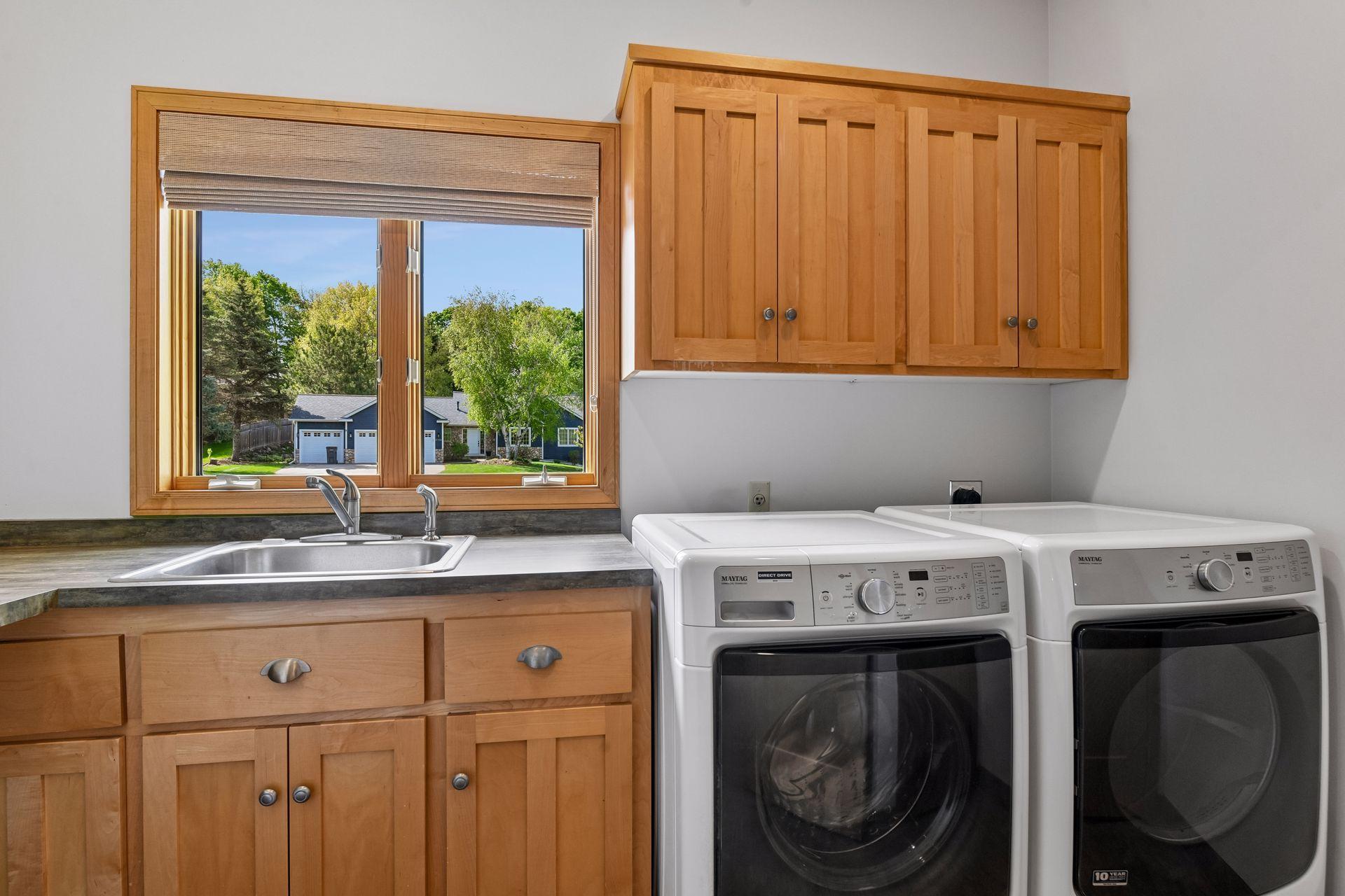 Laundry room with plenty of storage, sink and folding counter